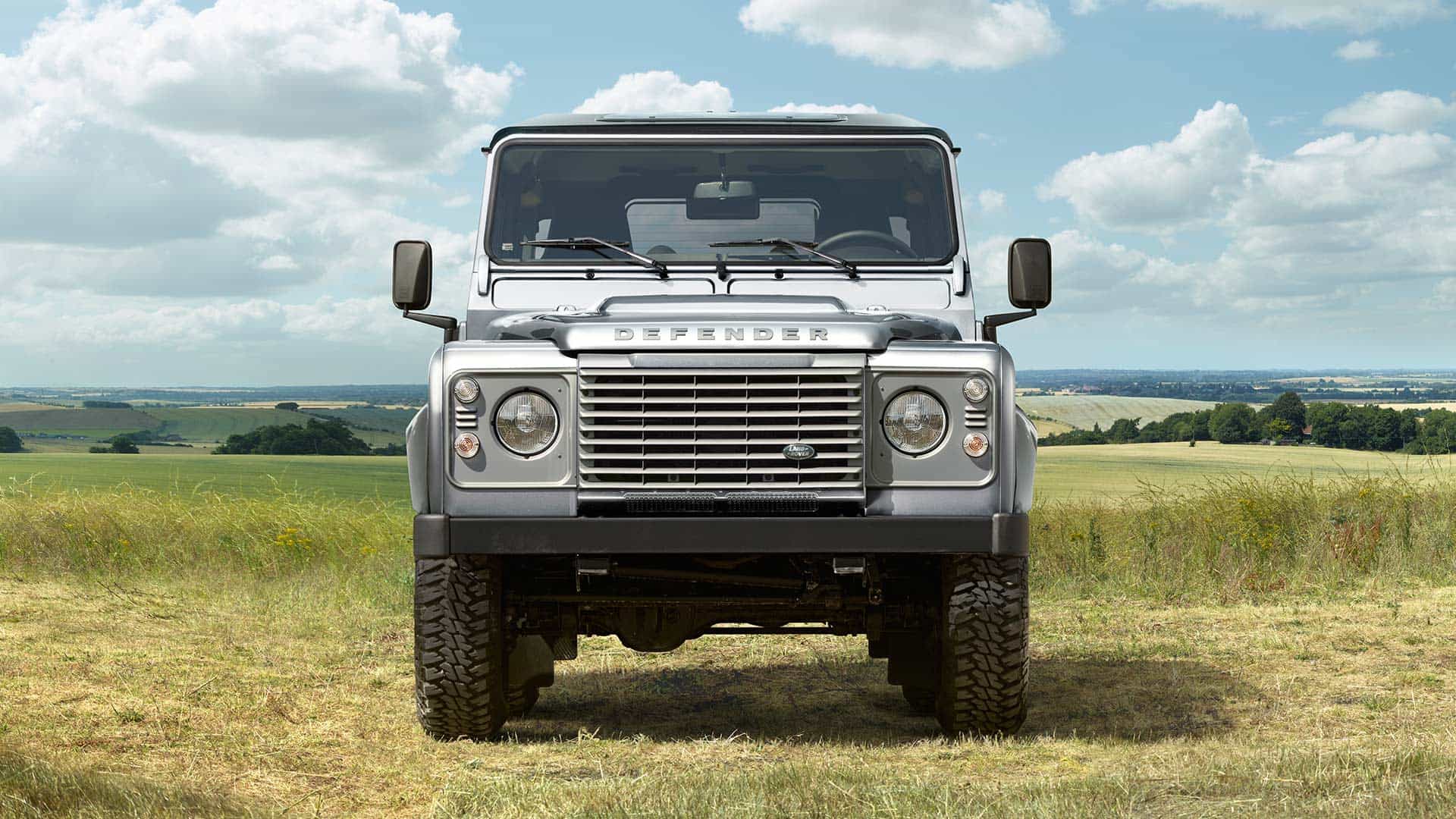 A Defender parked in a field