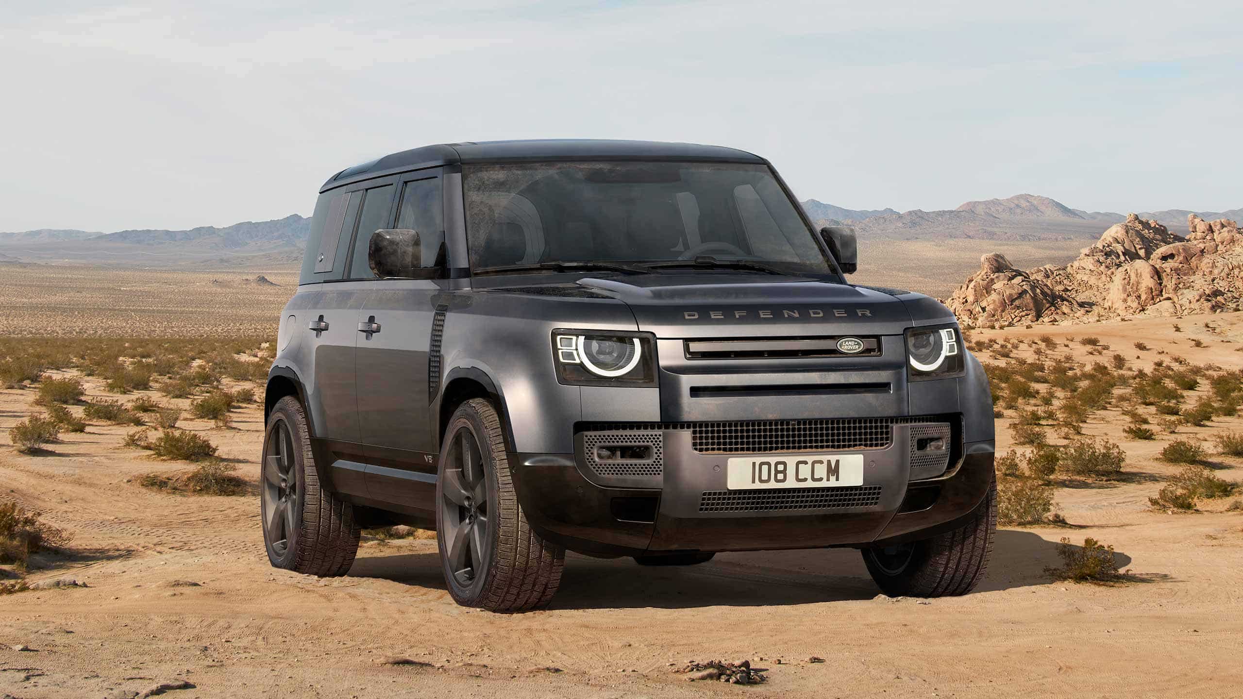 Land Rover Defender black in desert scenery