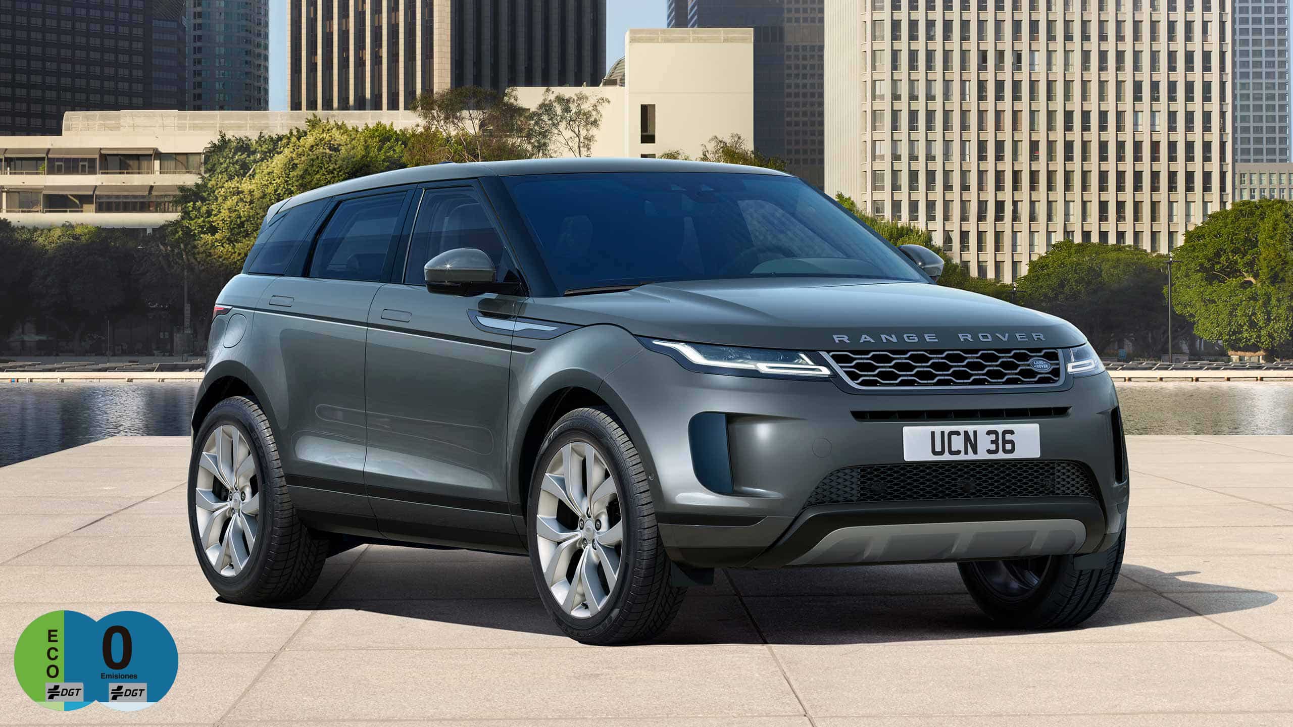Evoque Parked By Garden Area Against Buildings In City
