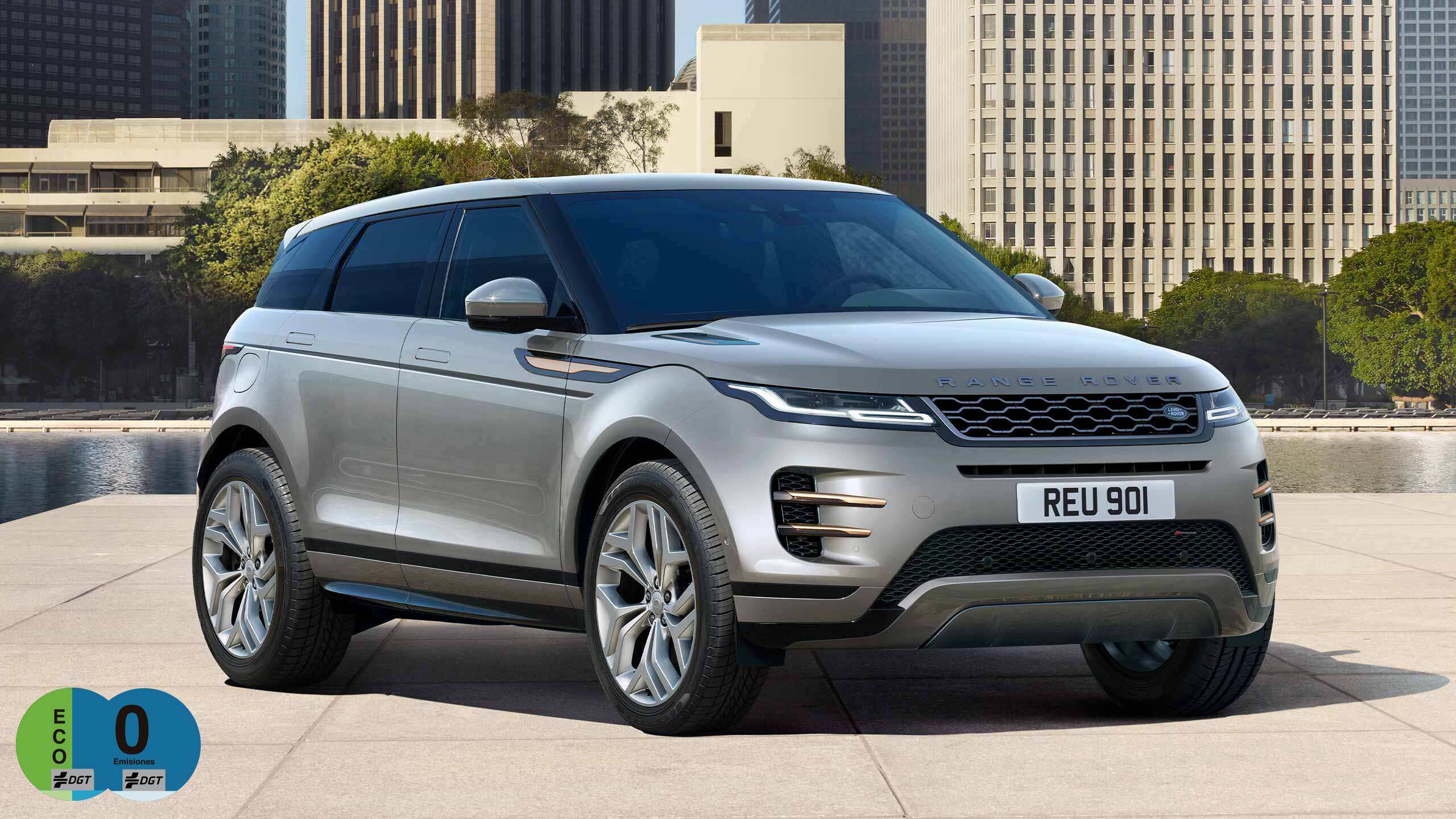 Evoque Parked By Garden Area Against Buildings In City