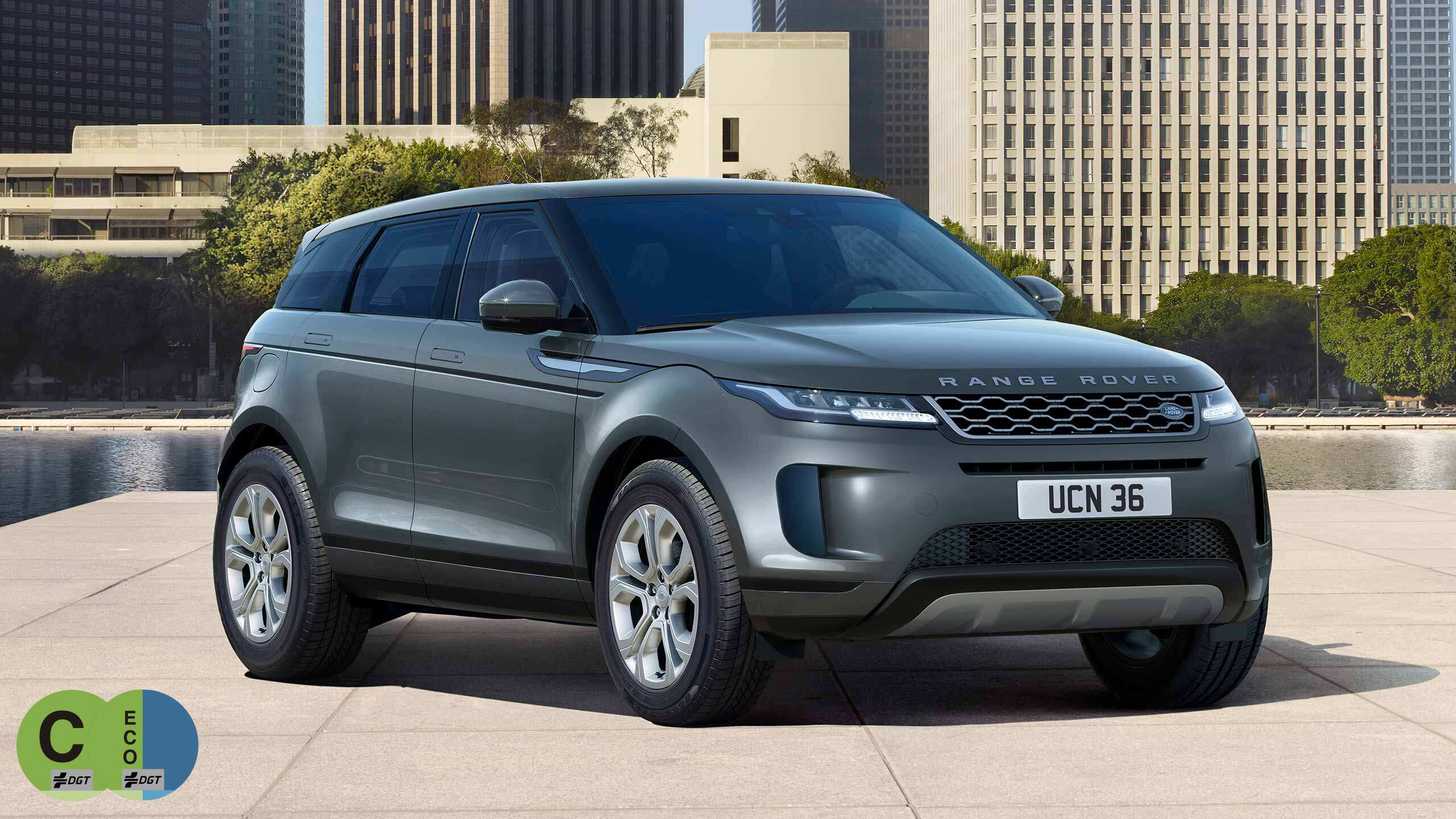 Evoque Parked By Garden Area Against Buildings In City