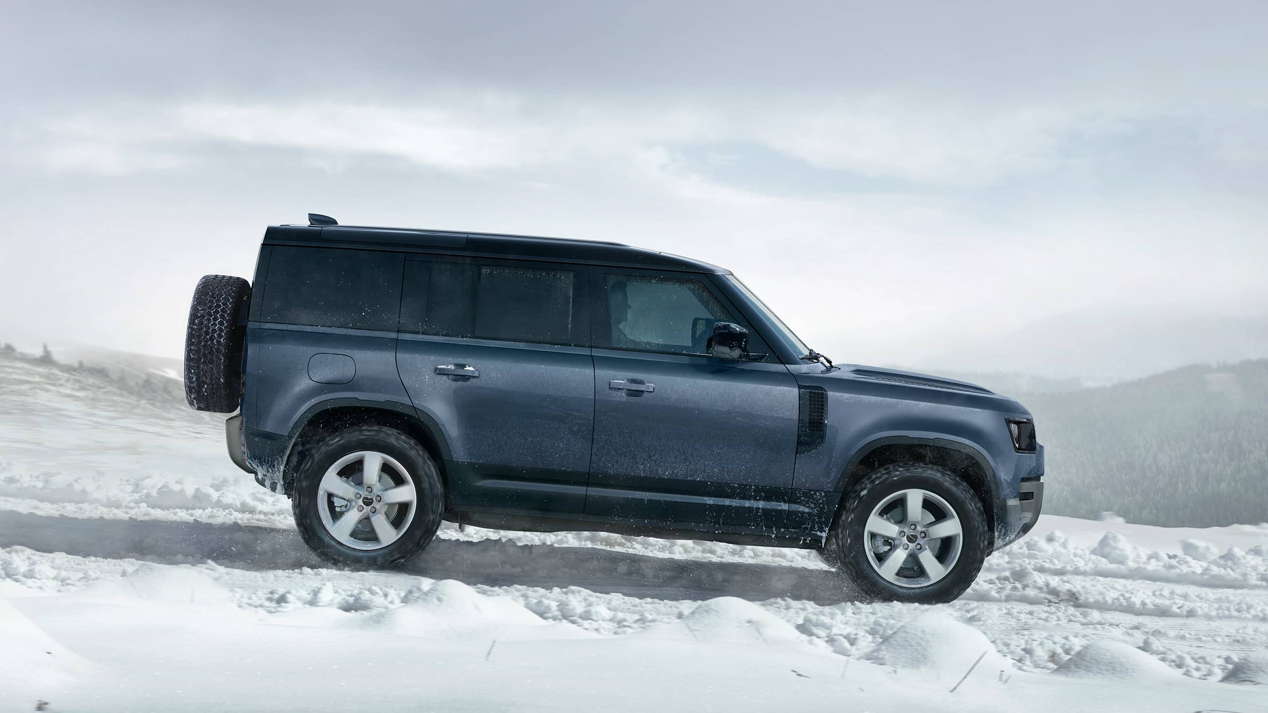 Defender driving on snowy off-road